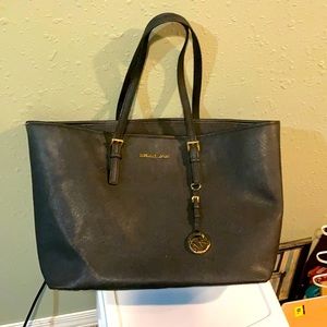 Large tote Micheal Kors brand black in color